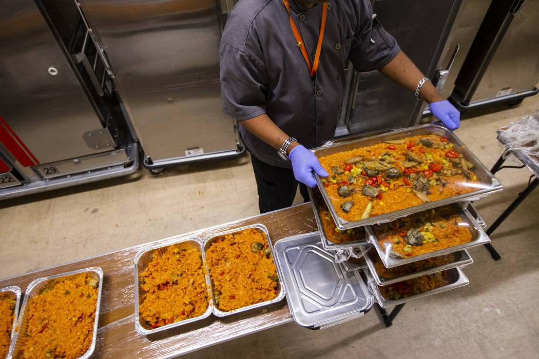 Sarif El-Amin, of Three Square food bank, packages vegan jambalaya and other surplus banquet fo ...