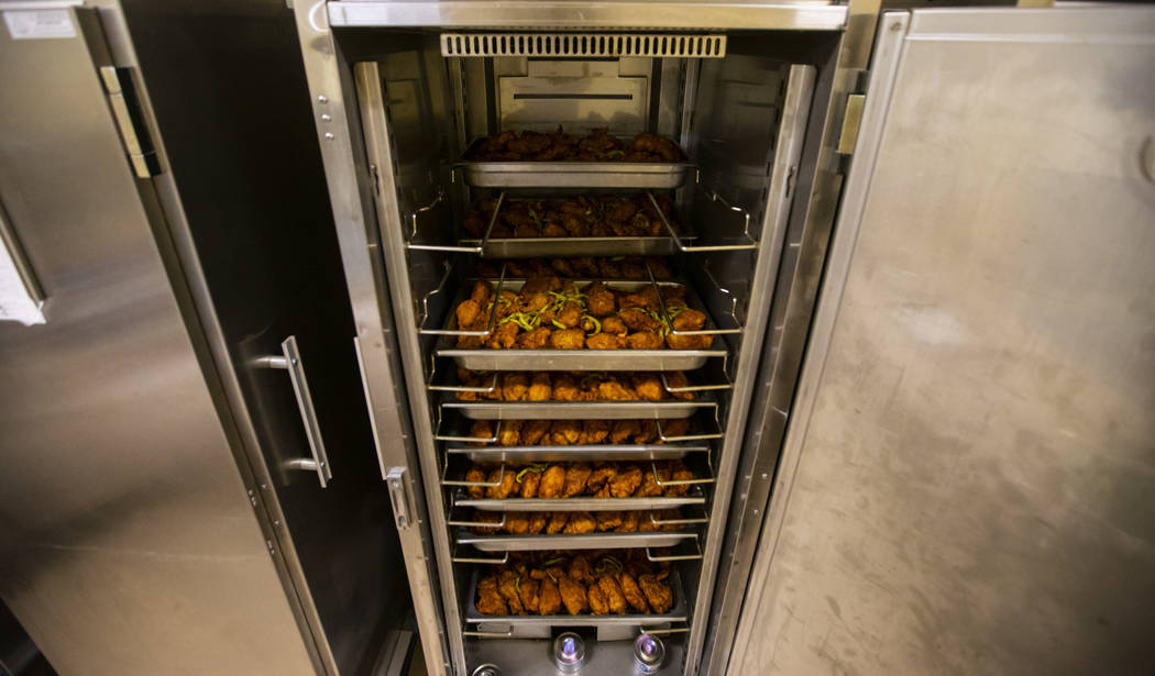 Racks of fried chicken to be donated to Three Square food bank, as part of the surplus banquet ...