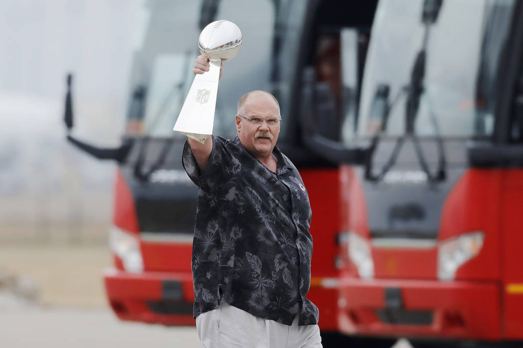 Kansas City Chiefs head coach Andy Reid holds up the Vince Lombardi Trophy as his team returns ...