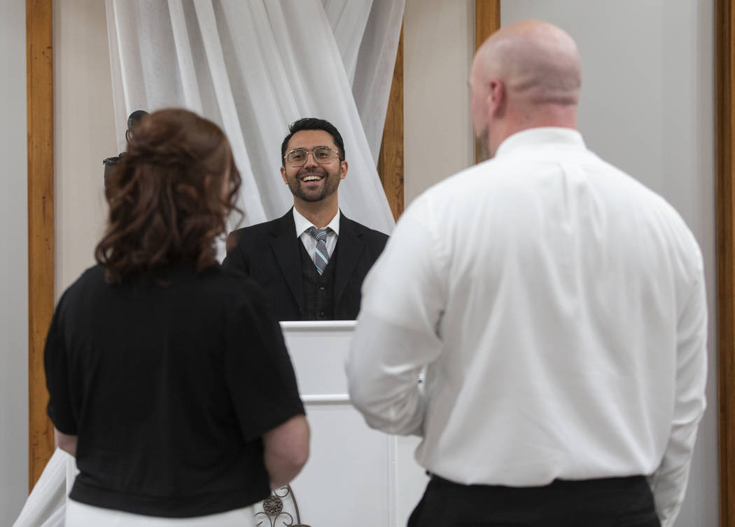 Mike Kelly, middle, owner of The Little Vegas Chapel, officiates over the wedding of Jordan Wil ...