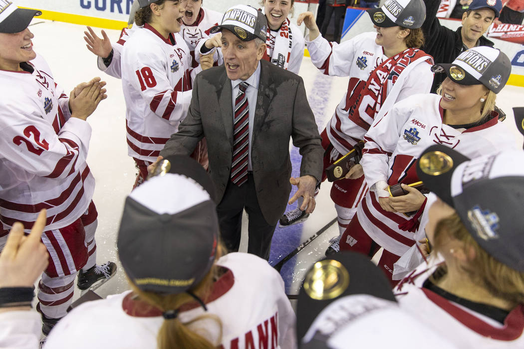 Wisconsin head coach Mark Johnson, center, celebrates with his players after the University of ...