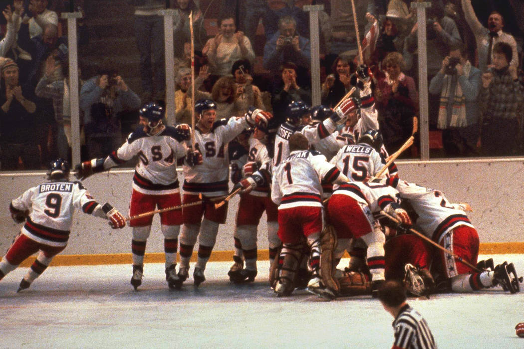 FILE -In this Feb. 22, 1980 file photo, the U.S. hockey team pounces on goalie Jim Craig after ...