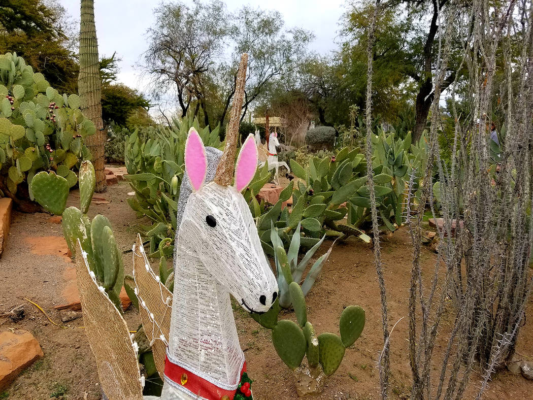 A glittering unicorn decoration mixes with the 300 cactus and desert plant species in Ethel M's ...