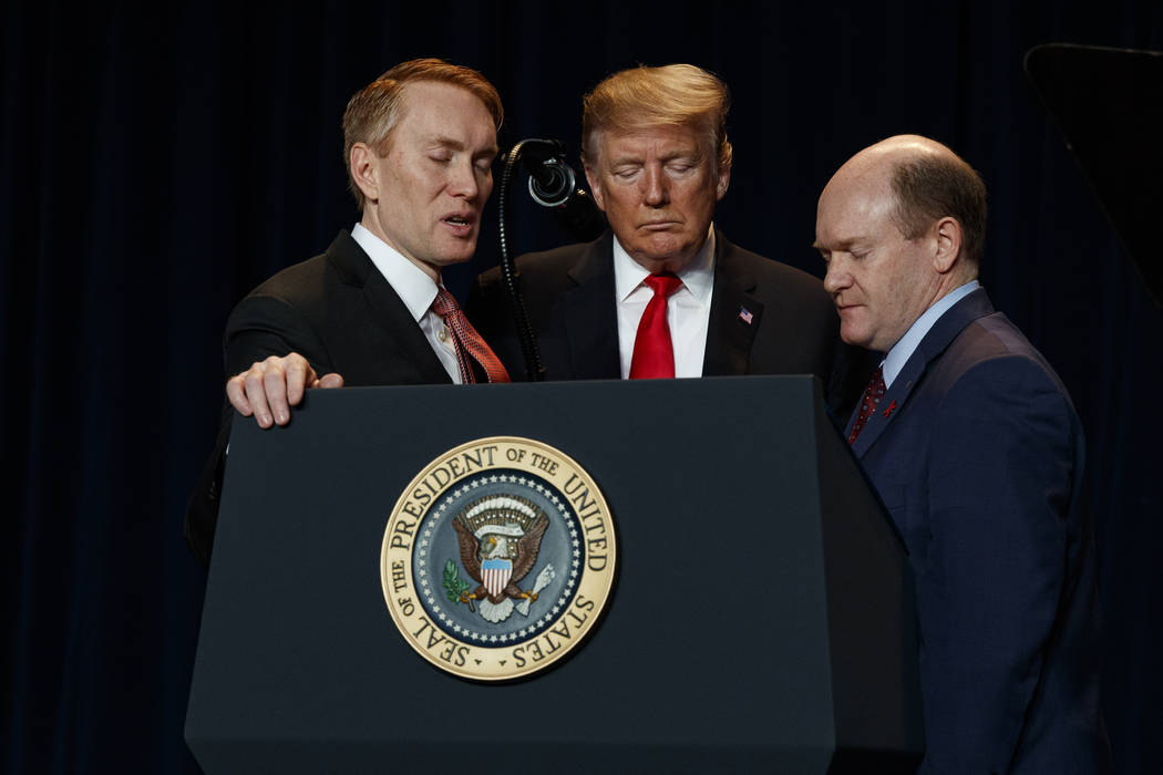 Rep. James Lankford, R-Okla., left, President Donald Trump, center, and Sen. Chris Coons, D-Del ...