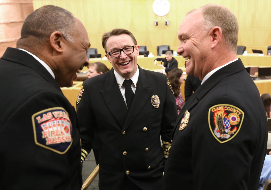 Incoming Clark County Fire Department Chief John Steinbeck, center, visits with Las Vegas Fire ...
