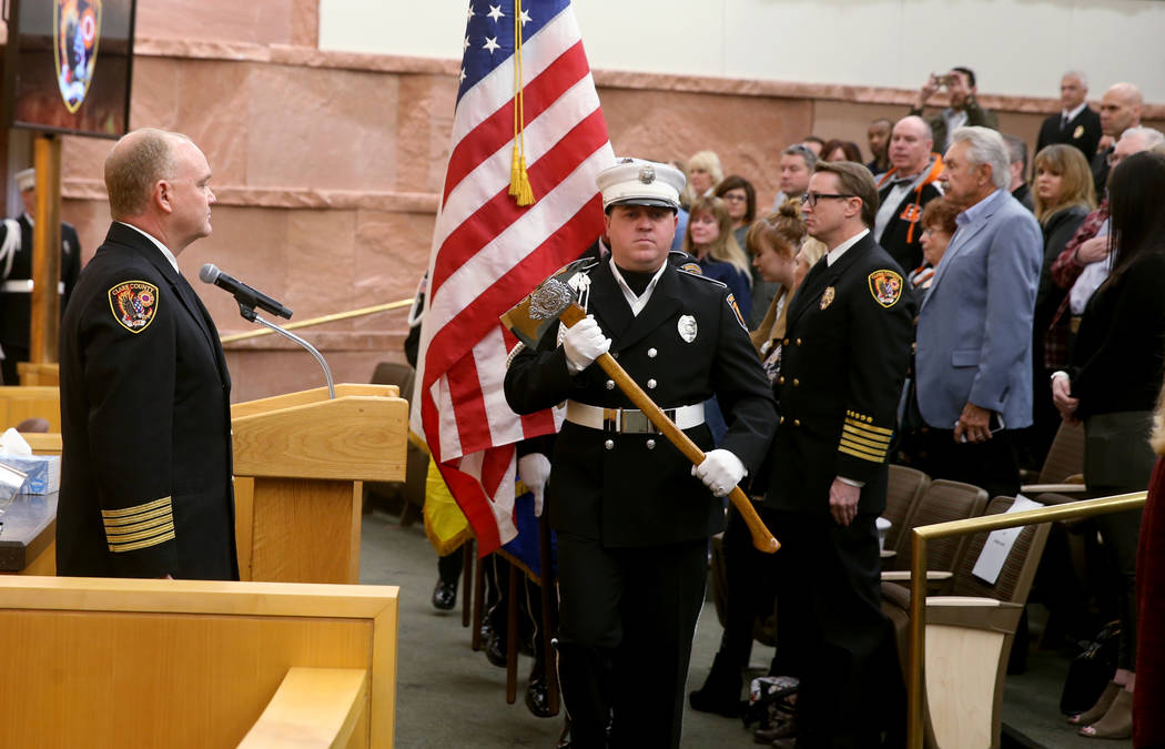 The Clark County Fire Department honor guard presents the colors between outgoing Fire Chief Gr ...