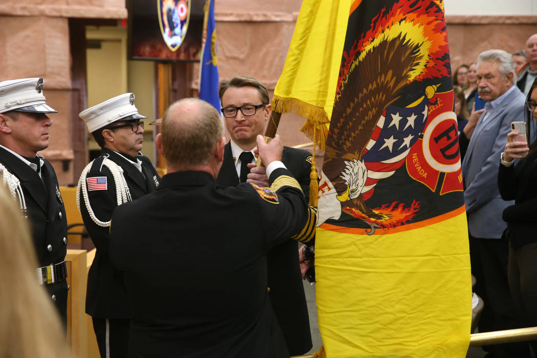 Outgoing Clark County Fire Department Chief Greg Cassell, left, turns over command of the depar ...
