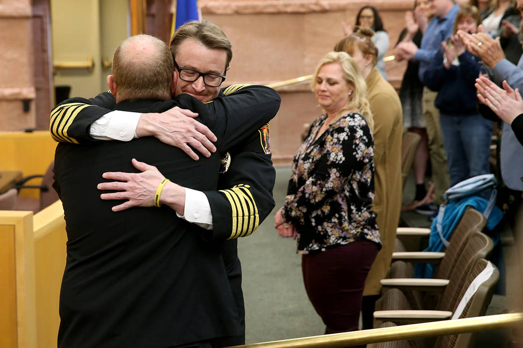 Outgoing Clark County Fire Department Chief Greg Cassell, left, hugs new Chief John Steinbeck a ...