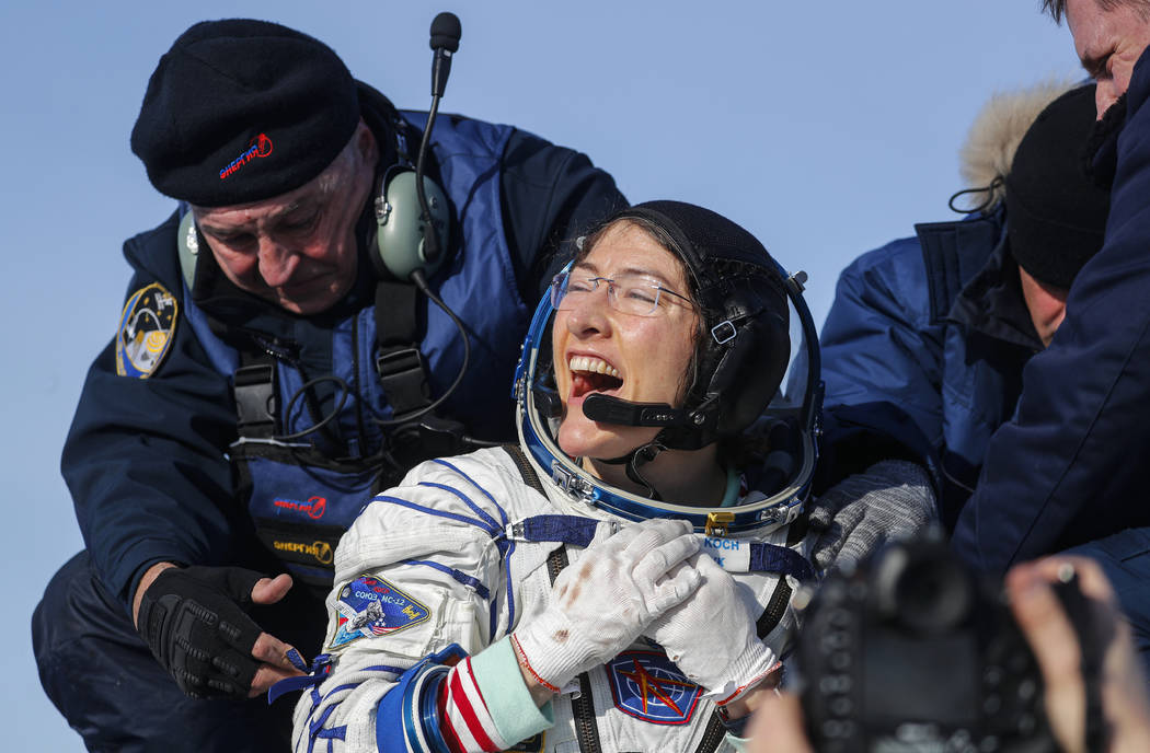 U.S. astronaut Christina Koch reacts shortly after the landing of the Russian Soyuz MS-13 space ...
