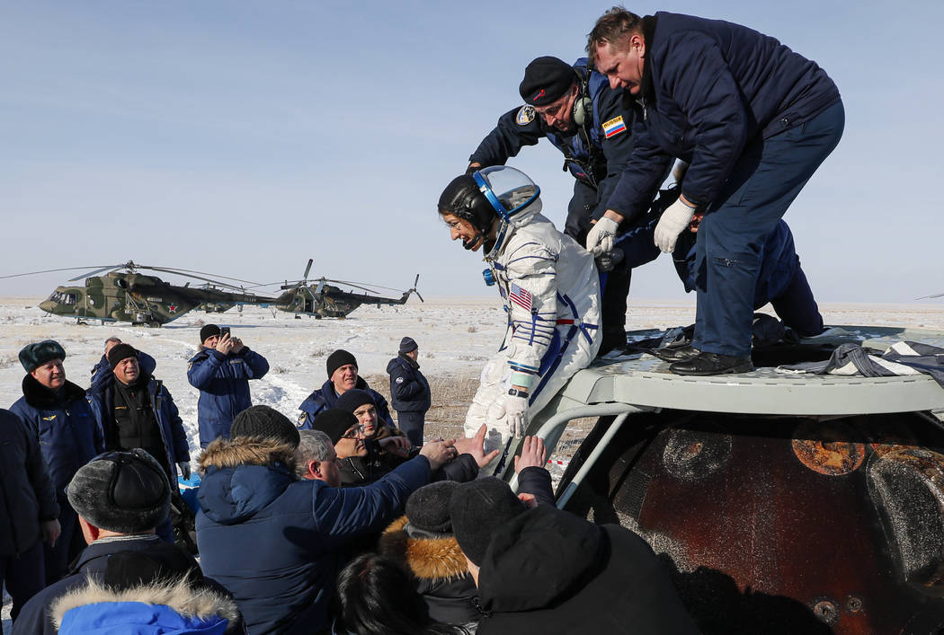 Russian space agency rescue team help U.S. astronaut Christina Koch to get from the capsule sho ...