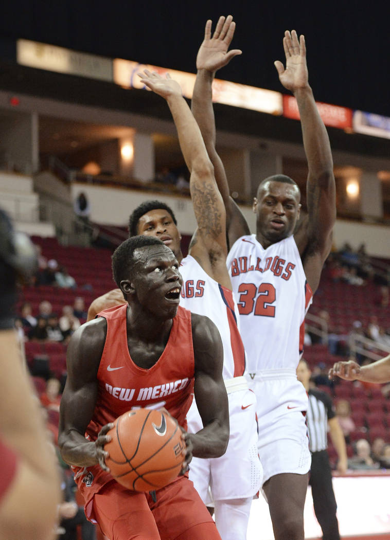 New Mexico's Makuach Maluach, left, looks to go to the hoop against Fresno State's Nate Grimes, ...