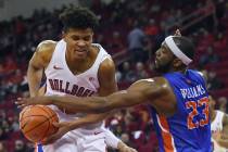 Boise State's RJ Williams, right, gets a hand on the ball carried by Fresno State's Orlando Rob ...