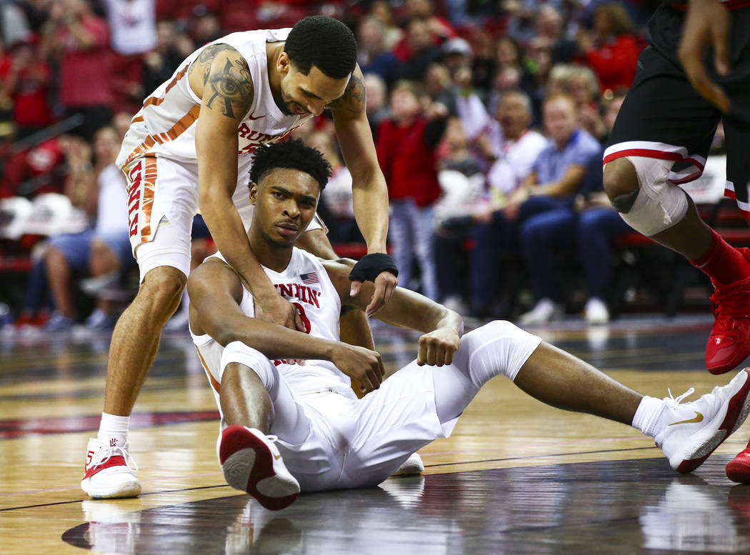 UNLV's guard Bryce Hamilton, center, reacts with teammate Elijah Mitrou-Long (55) after drawing ...