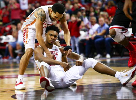 UNLV's guard Bryce Hamilton, center, reacts with teammate Elijah Mitrou-Long (55) after drawing ...