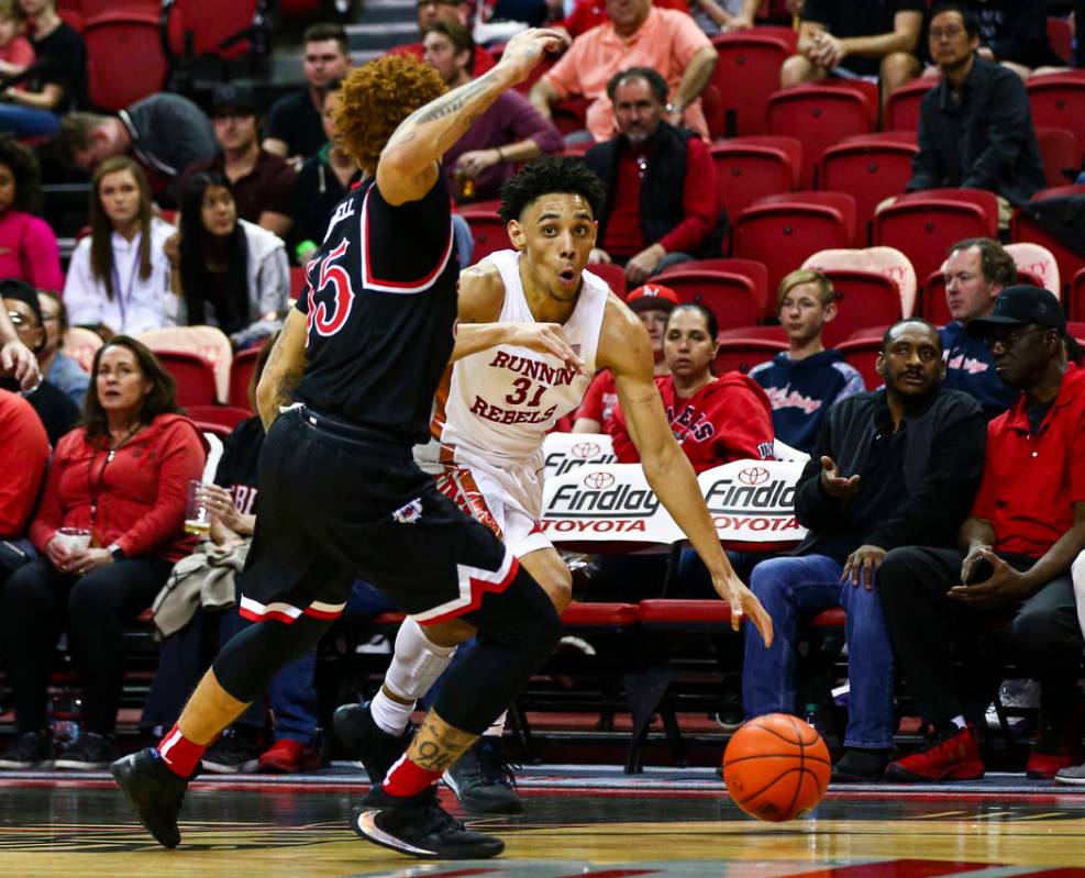 UNLV's Marvin Coleman (31) drives to the basket against Fresno State's Noah Blackwell (55) duri ...