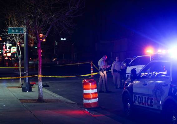 Las Vegas police officers investigate the scene of a shooting on Fremont Street between 14th an ...