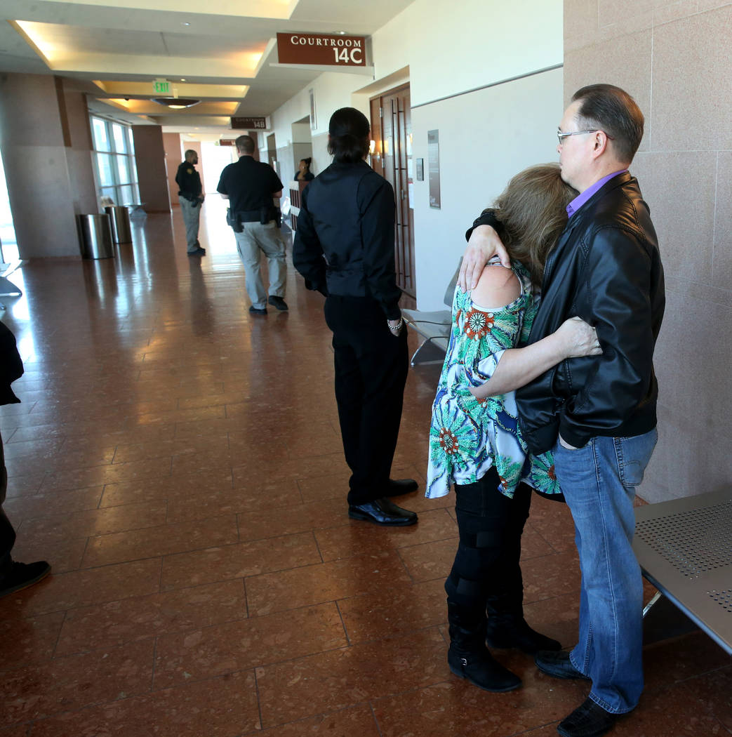 Dennis and Theresa Christensen, parents of murder victim Matthew Christensen, hug outside the c ...