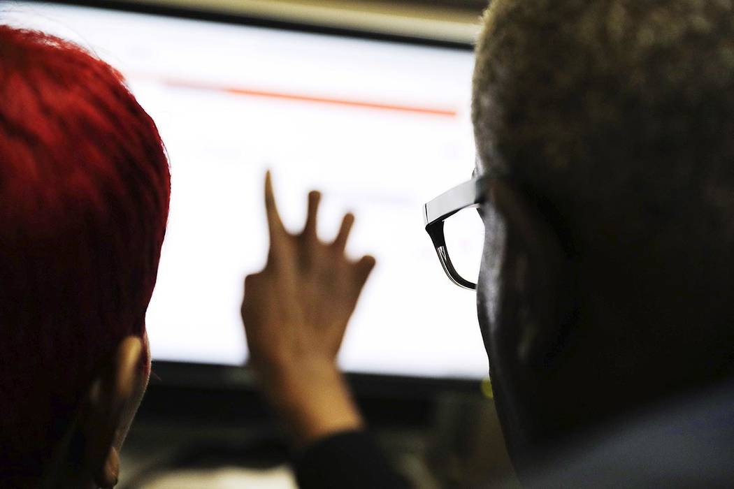 In a March 3, 2016, file photo, two people work on a computer in Atlanta. Researchers who study ...