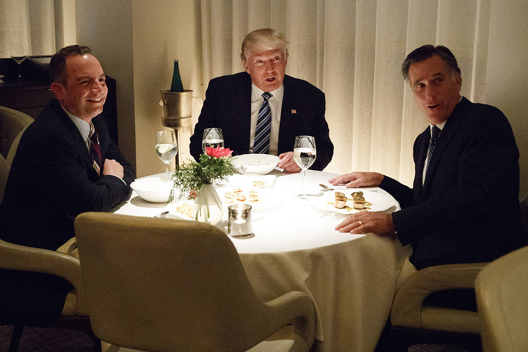 President-elect Donald Trump, center, eats dinner with Mitt Romney, right, and Trump Chief of S ...