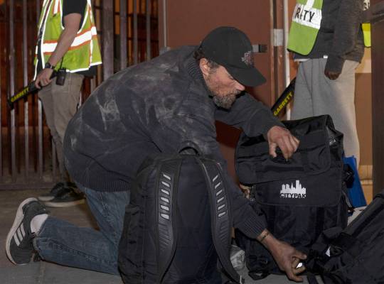 Shane Horton of Las Vegas closes his new CITYPAK backpack after filling it with his belongings ...