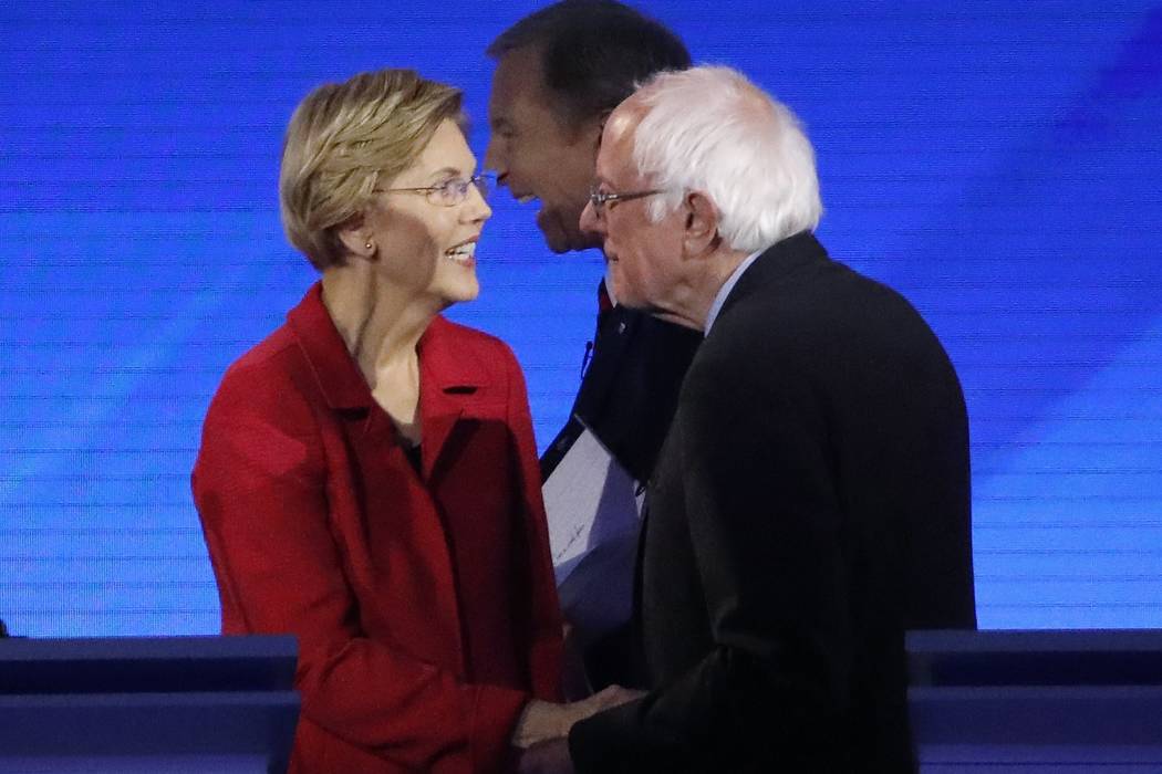 Sen. Elizabeth Warren, D-Mass., left, speaks to Sen. Bernie Sanders, I-Vt., after a Democratic ...