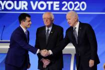 From left, Democratic presidential candidates former South Bend Mayor Pete Buttigieg, shakes ha ...