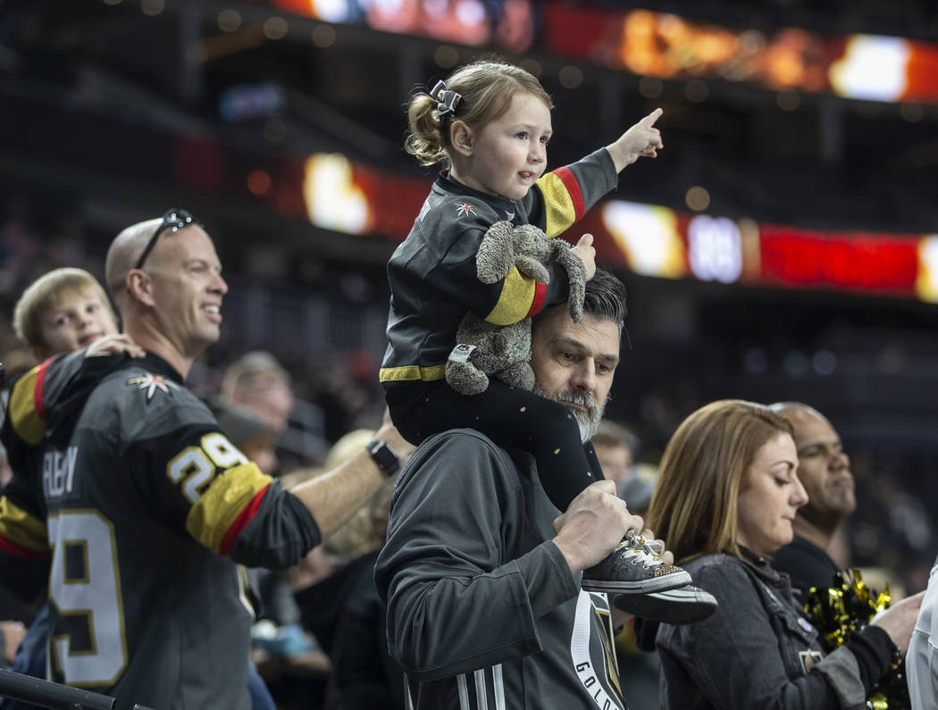 Goldens Knights fans cheer for Vegas before the start of their NHL hockey game with the Carolin ...