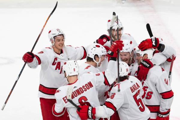 Carolina Hurricanes players celebrate after beating the Golden Knights 6-5 in a shoutout during ...