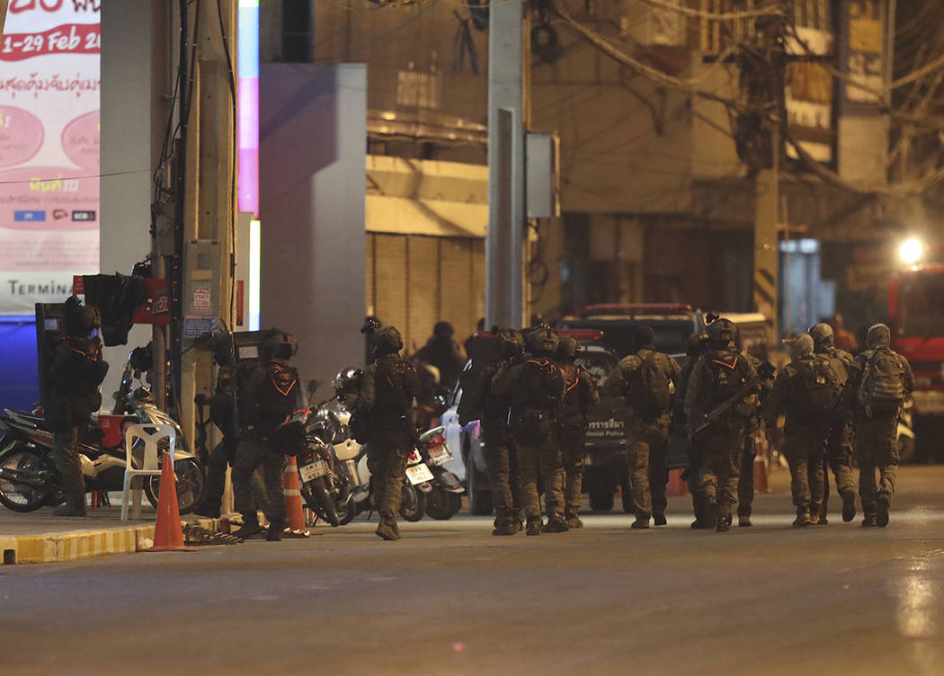 A group of armed commando soldiers are seen walking outside Terminal 21 Korat mall, in Nakhon R ...