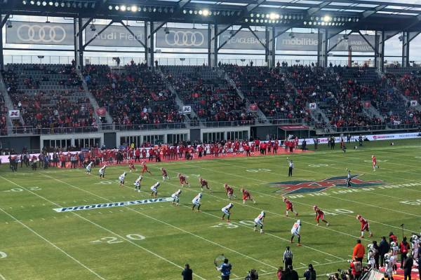 The D.C. Defenders, right, line up against the Seattle Dragons for the opening kickoff of the o ...