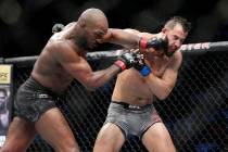 Jon Jones, left, connects with a punch to the face of Dominick Reyes, right, during a light hea ...