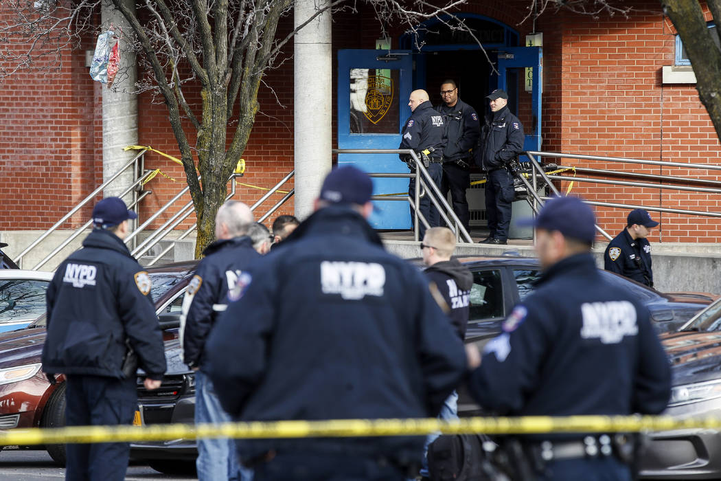 New York City police officers work the scene of a police involved shooting outside the 41st pre ...