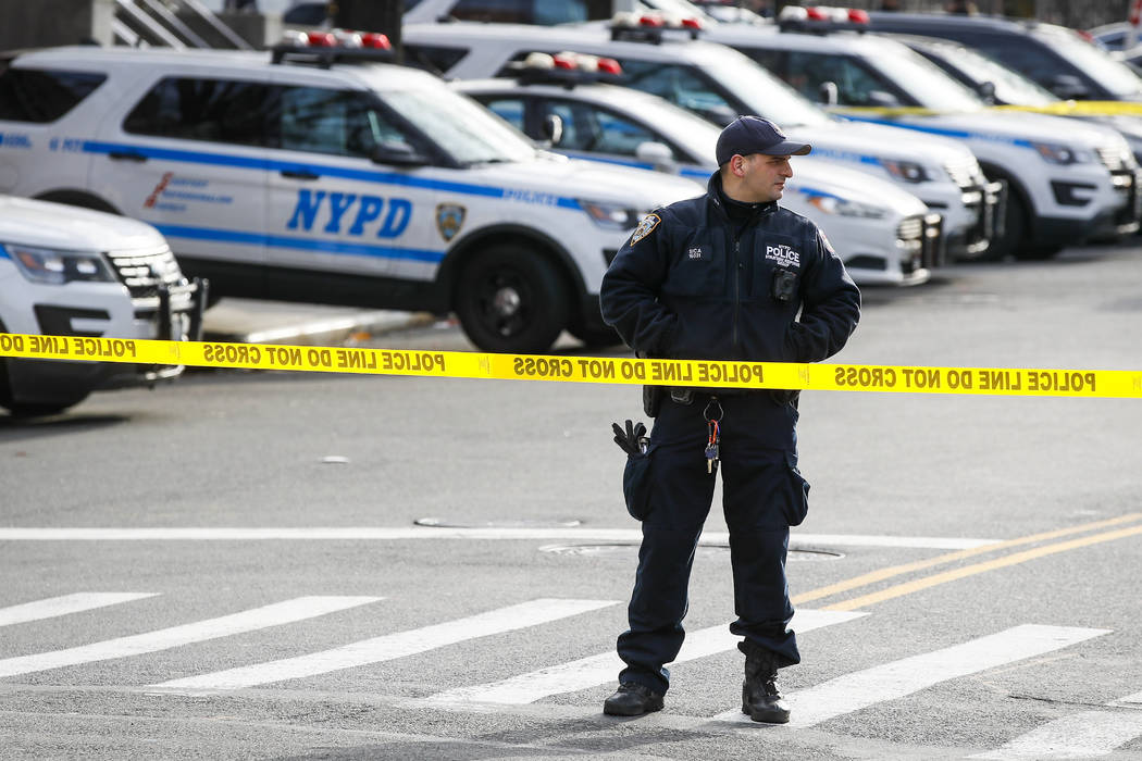 New York police set up a perimeter outside the 41st police precinct at the scene of a police in ...