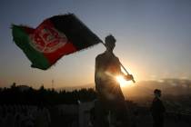 FILE - In this Aug. 19, 2019, file photo, a man waves an Afghan flag during Independence Day ce ...