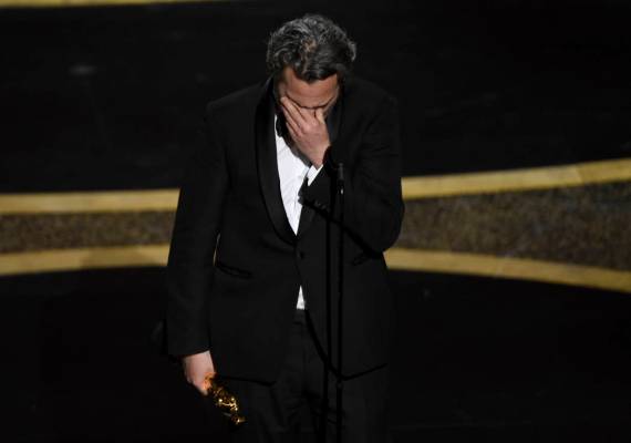 Joaquin Phoenix reacts as he accepts the award for best performance by an actor in a leading ro ...