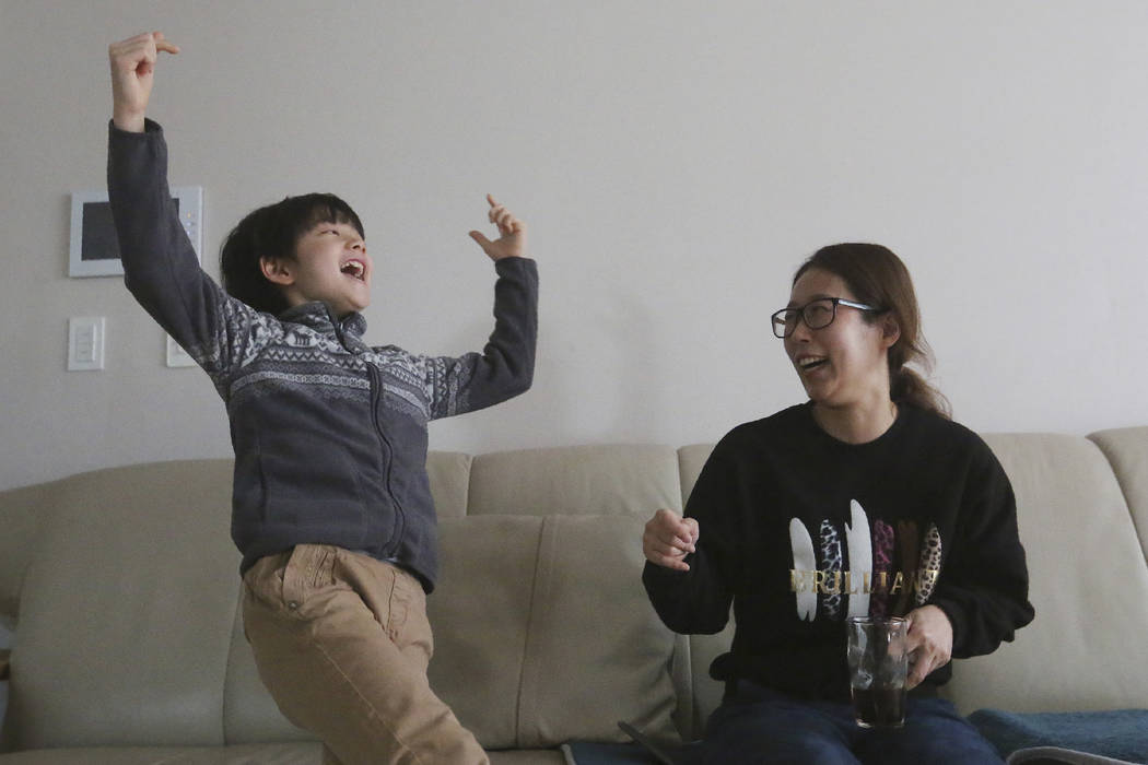 Parasite actor Jeong Hyeonjun, left, and his mother Lee Min Jae celebrate as they watch a TV li ...