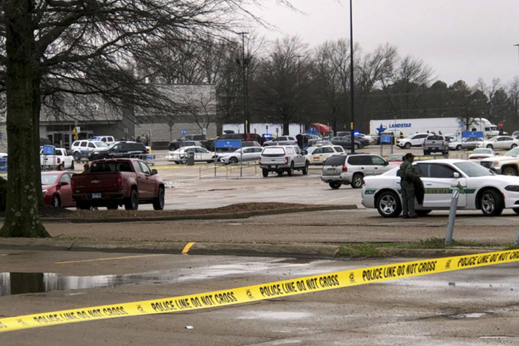 Law enforcement officials block off a Walmart store in Forrest City, Ark., on Monday, Feb. 10, ...