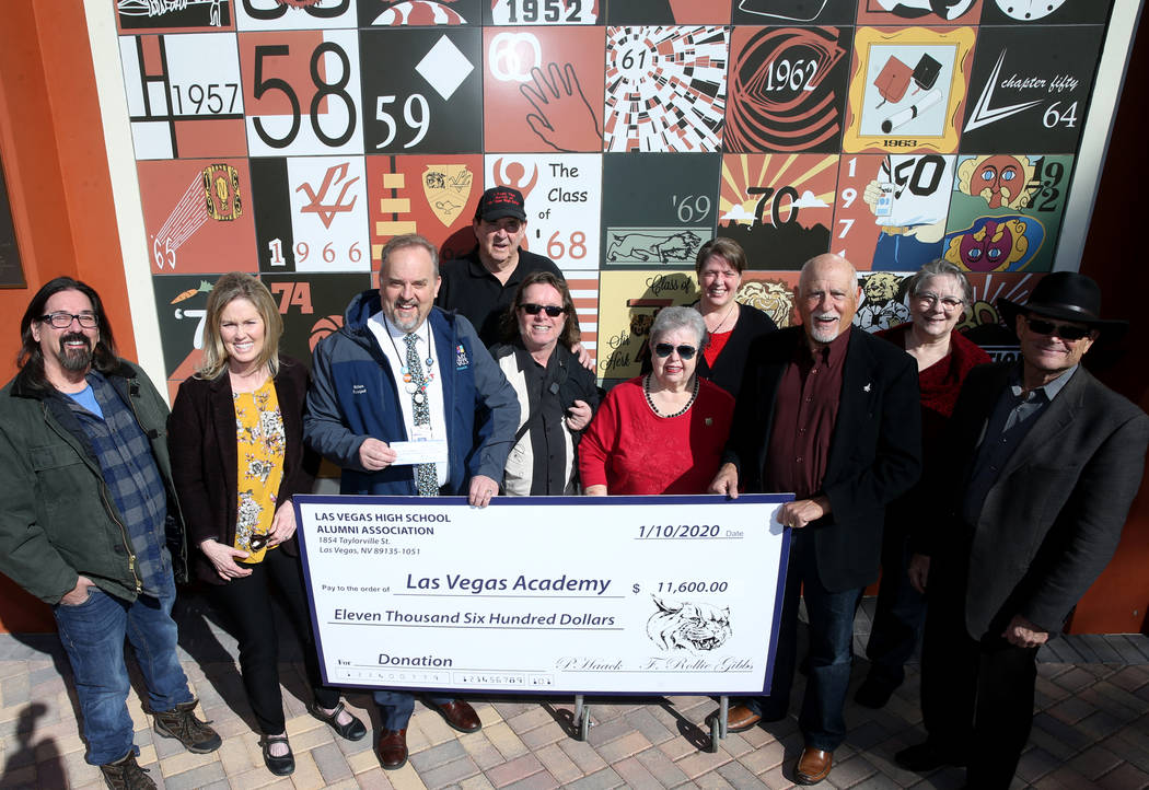 Las Vegas Academy principal Scott Walker, third from left, poses with alumni, from left, Joe Th ...