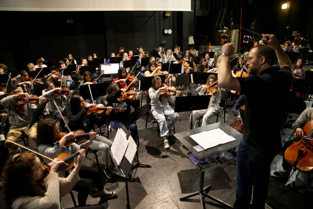 Las Vegas Academy Orchestra Director Eric McAllister rehearses with students in the school's ol ...