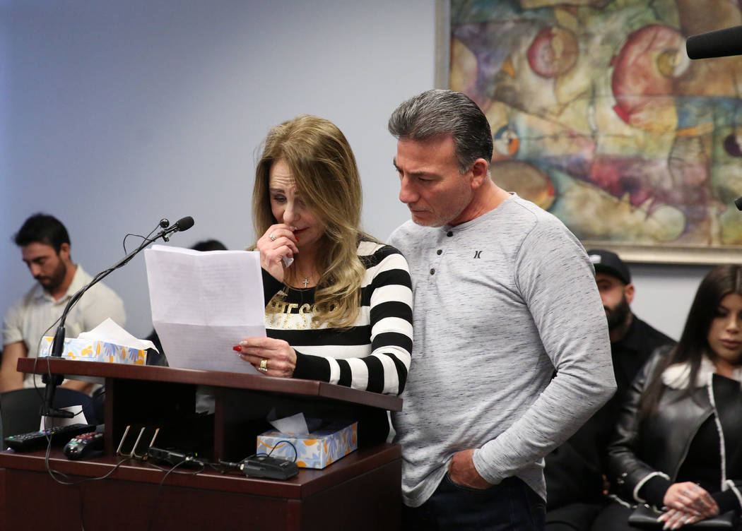 Saul Garibay comforts his wife Joyce, mother of 45-year-old Luis Campos, as she reads her state ...