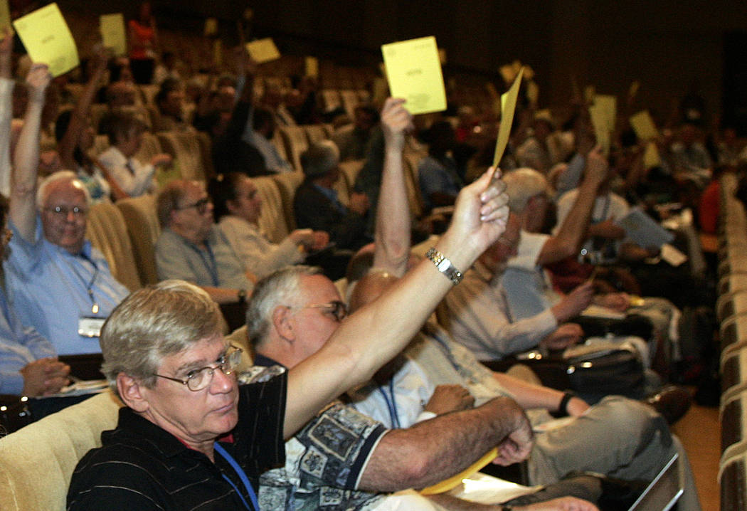Members of the International Astronomic Union (IAU), vote on a resolution for planet definition ...