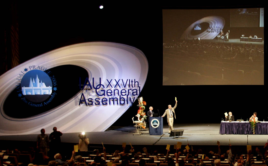 Members of the International Astronomic Union (IAU), vote on a resolution for planet definition ...