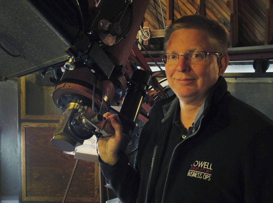 Kevin Schindler of Lowell Observatory stands next to the Pluto telescope in Flagstaff, Ariz., i ...