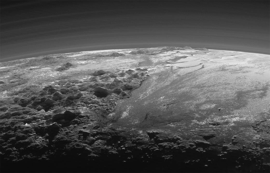 This 2015 photo shows the atmosphere and surface features of Pluto, lit from behind by the sun. ...