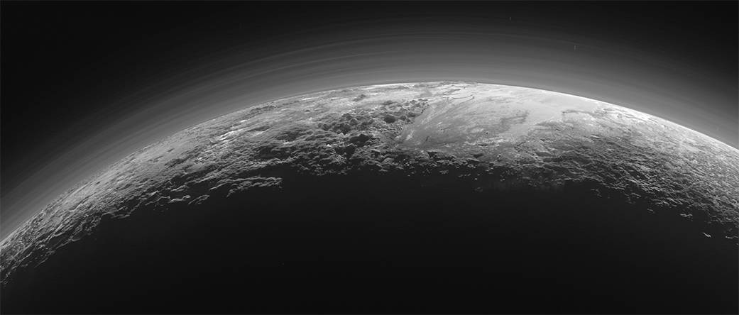 This 2015 photo shows the atmosphere and surface features of Pluto, lit from behind by the sun. ...