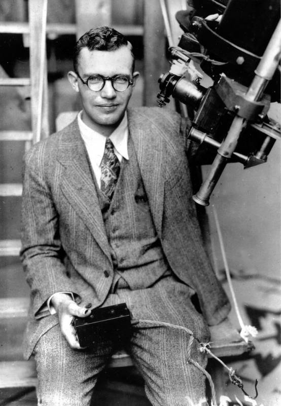 Clyde Tombaugh poses with the telescope through which he discovered the Pluto at the Lowell Obs ...
