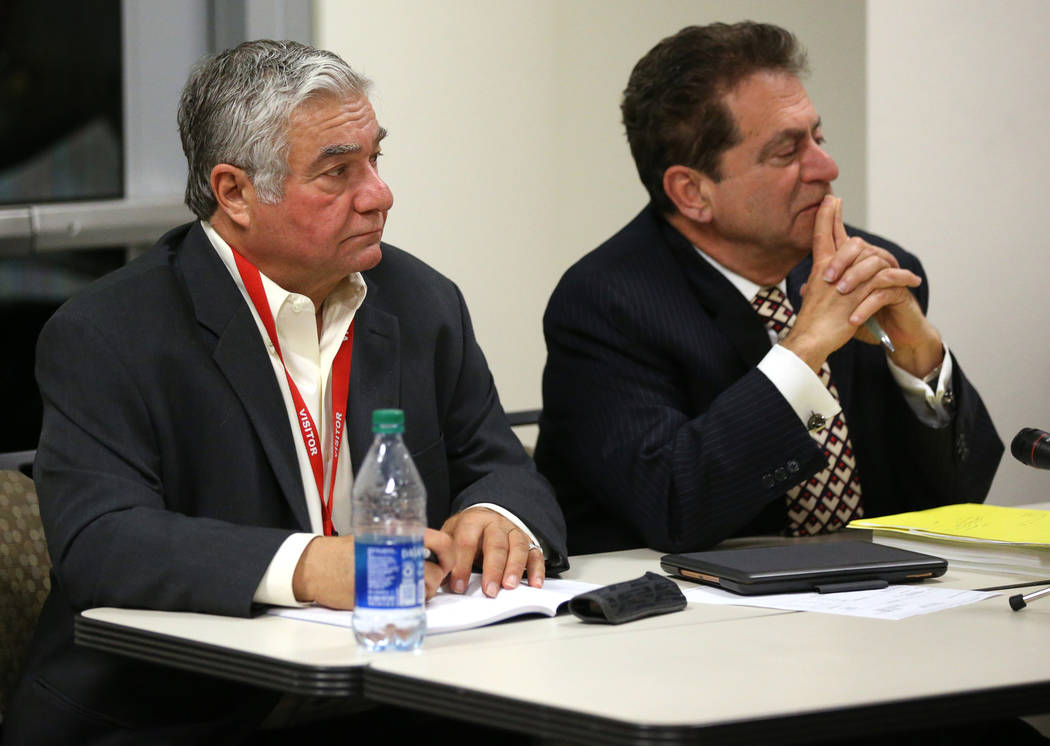 Former Henderson Constable Earl Mitchell, left, and his attorney Marc Risman listen to the the ...