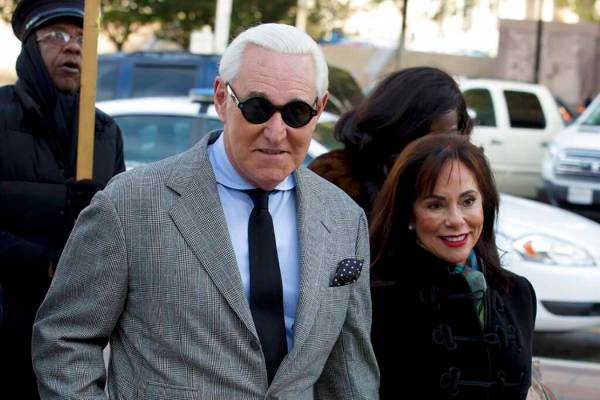 Roger Stone accompanied by his wife Nydia Stone, right, arrives at federal court in Washington, ...