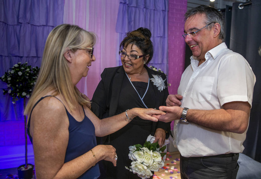 The Rev. Diana Moran, center, conducts a wedding renewal ceremony for Corrine Justeau, left, an ...