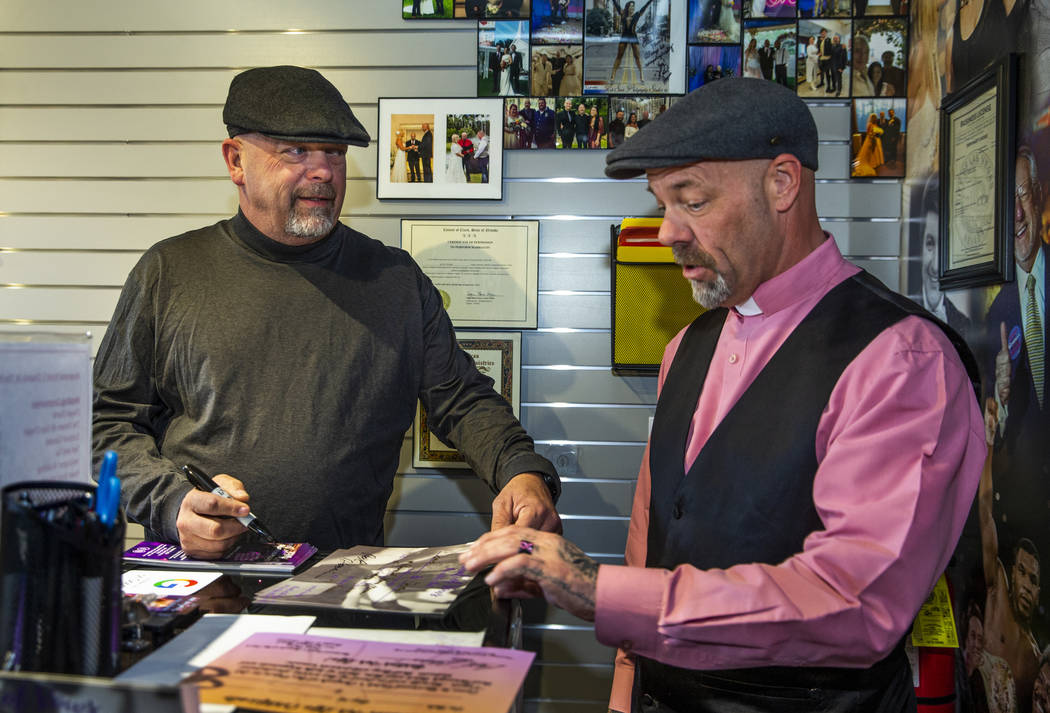 Gold & Silver Pawn Shop owner Rick Harrison, left, signs certificates for the Rev. Scott Po ...